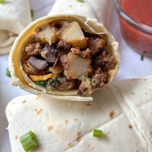 Breakfast burrito without eggs cut in half