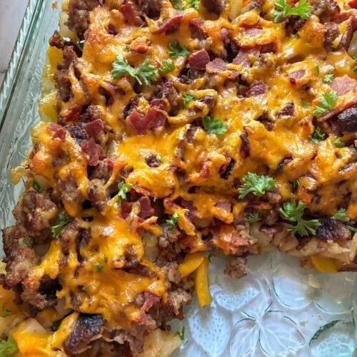 Eggless Breakfast Casserole in the casserole dish with a slice out of it