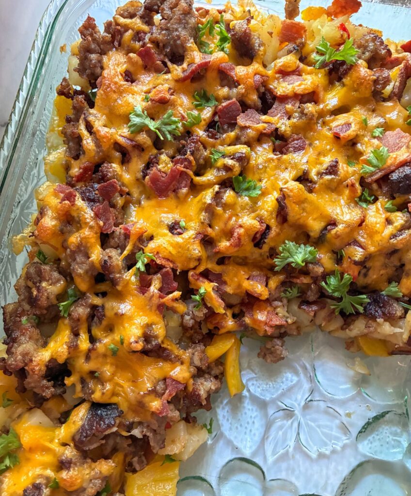 Eggless Breakfast Casserole in the casserole dish with a slice out of it