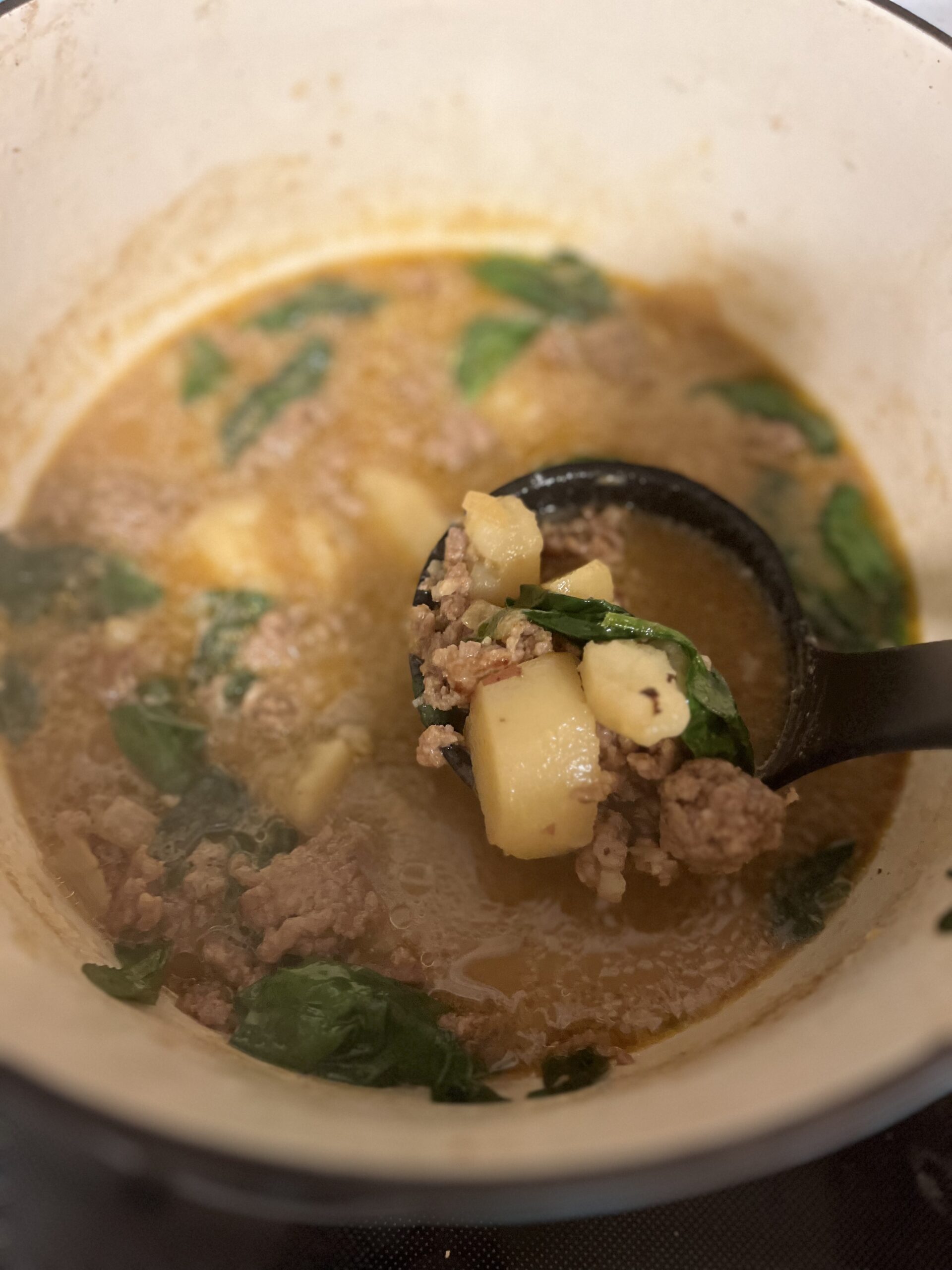 Sausage, potato and spinach soup in dutch oven finished cooking