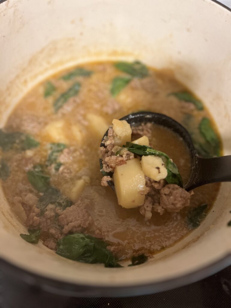 sausage, potato, and spinach soup in a large pot