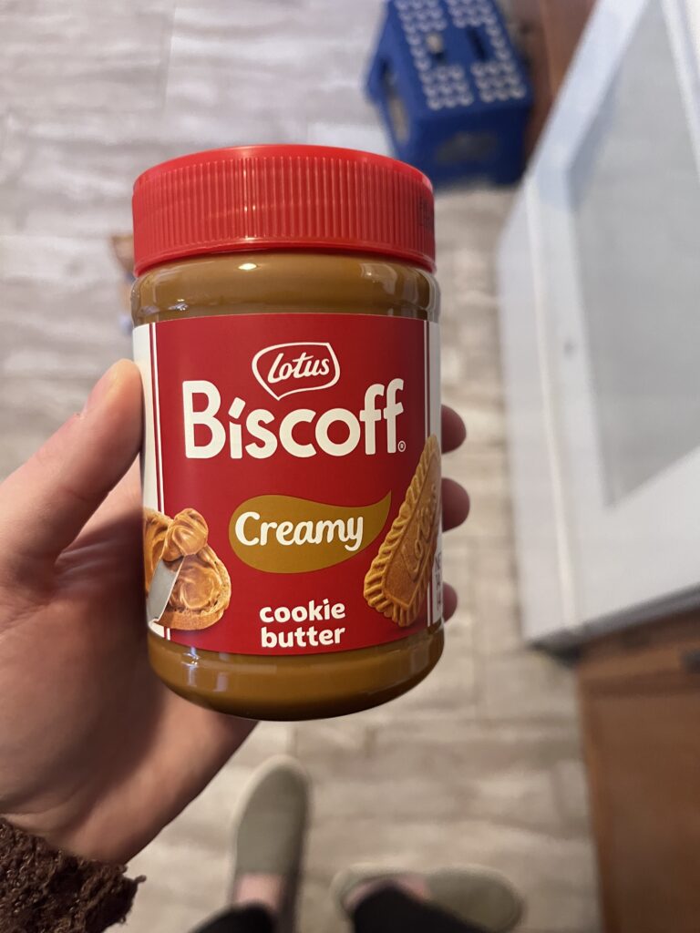 Author holding a jar of biscoff cookie butter. Showing this as a substitute for peanut butter