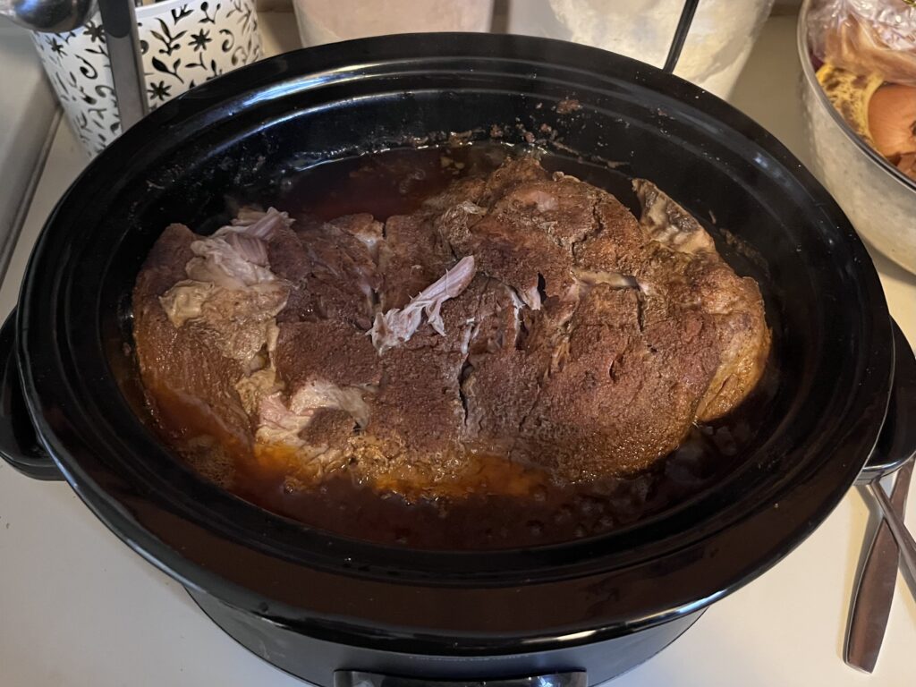 Cooked pork shoulder in crockpot