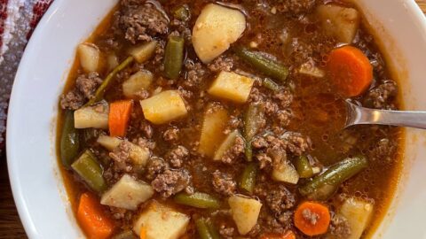 hamburger soup served in a bowl with a spoon