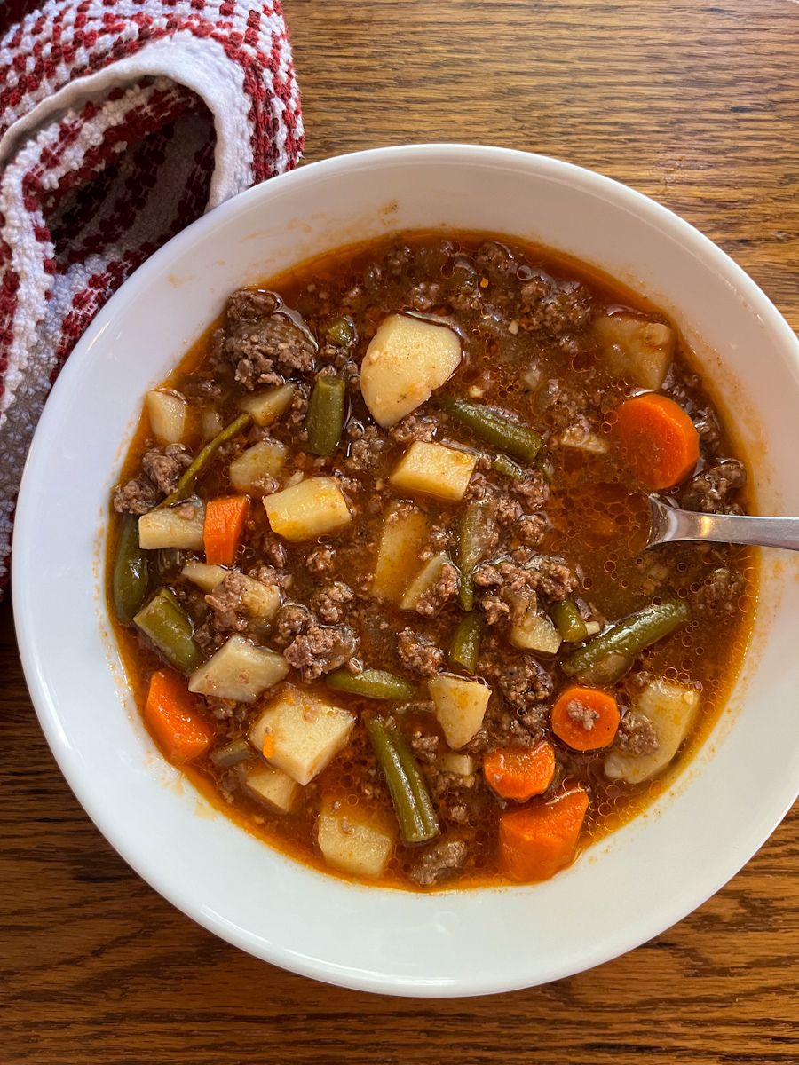 hamburger soup served in a bowl with a spoon