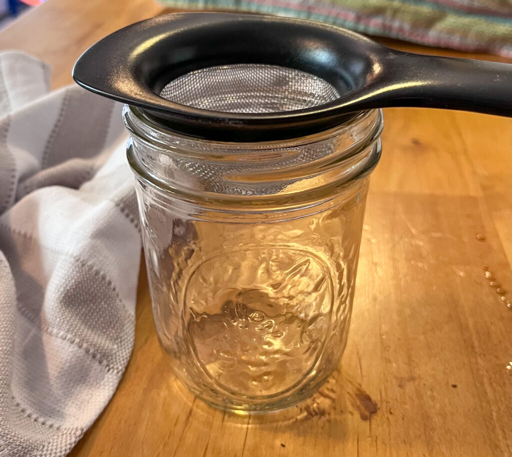 Mason jar with a strainer on top to help remove some undissolved cocoa powder from the drink