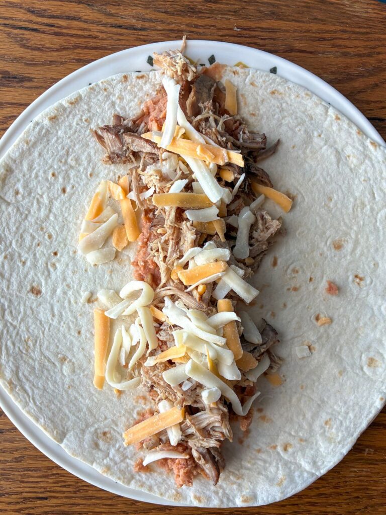 An open tortilla with filling placed in the center