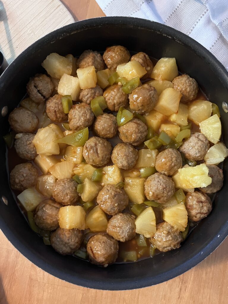 sweet and sour meatballs cooked and in a skillet