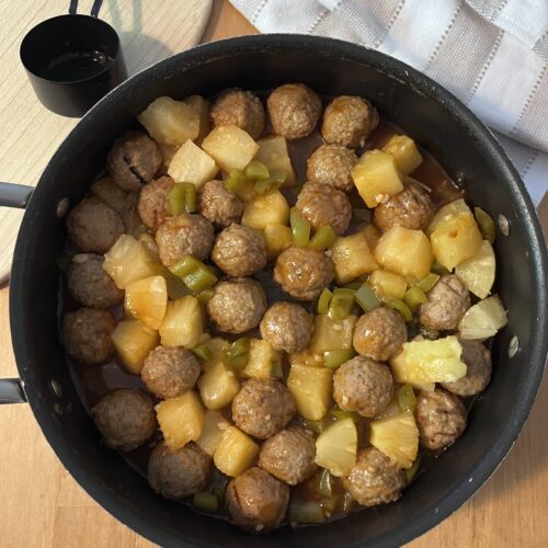 Sweet and sour meatballs cooked and served in a skillet