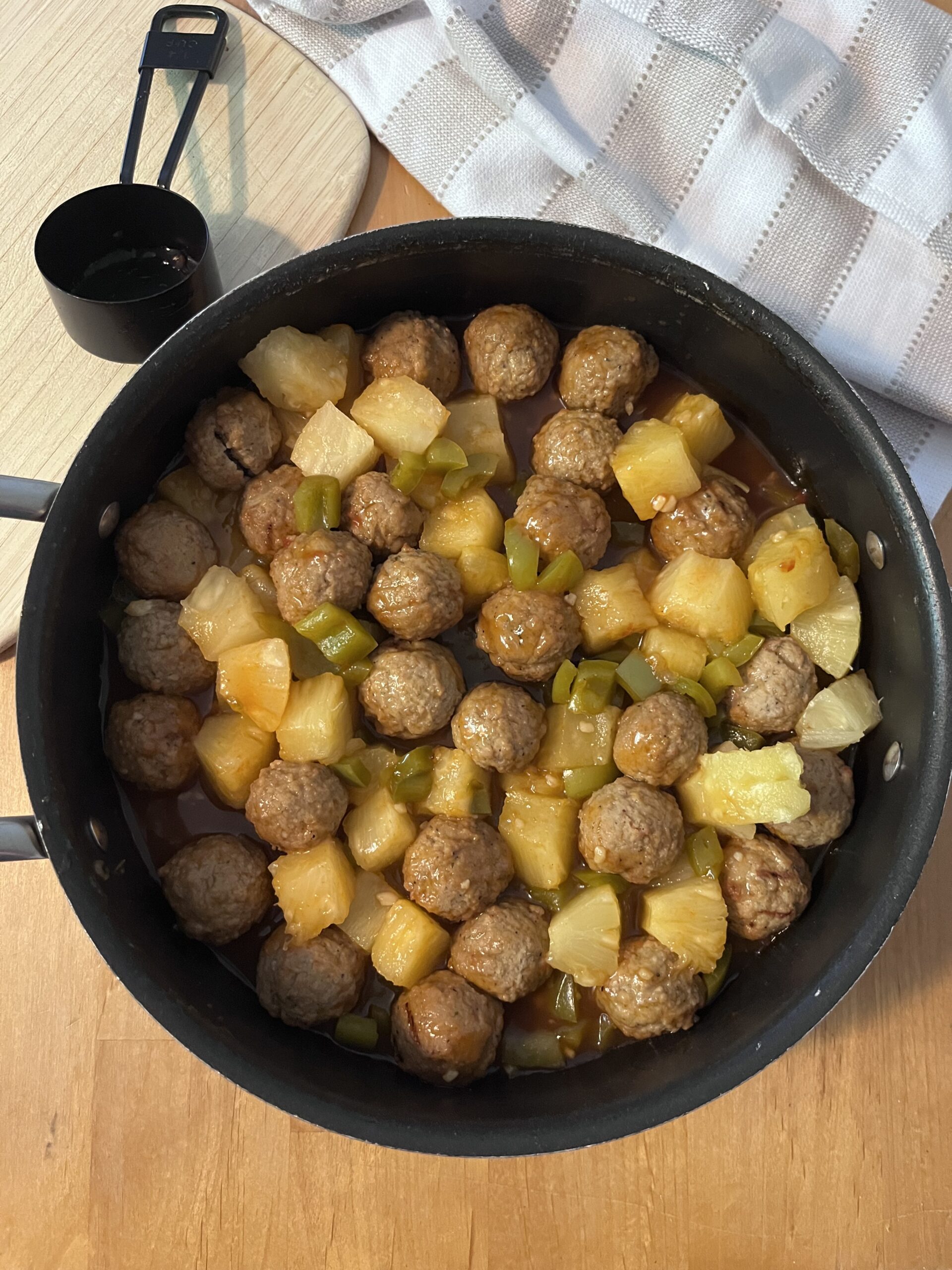 Sweet and sour meatballs cooked and served in a skillet