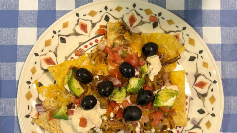 BBQ pulled pork nachos served on a plate