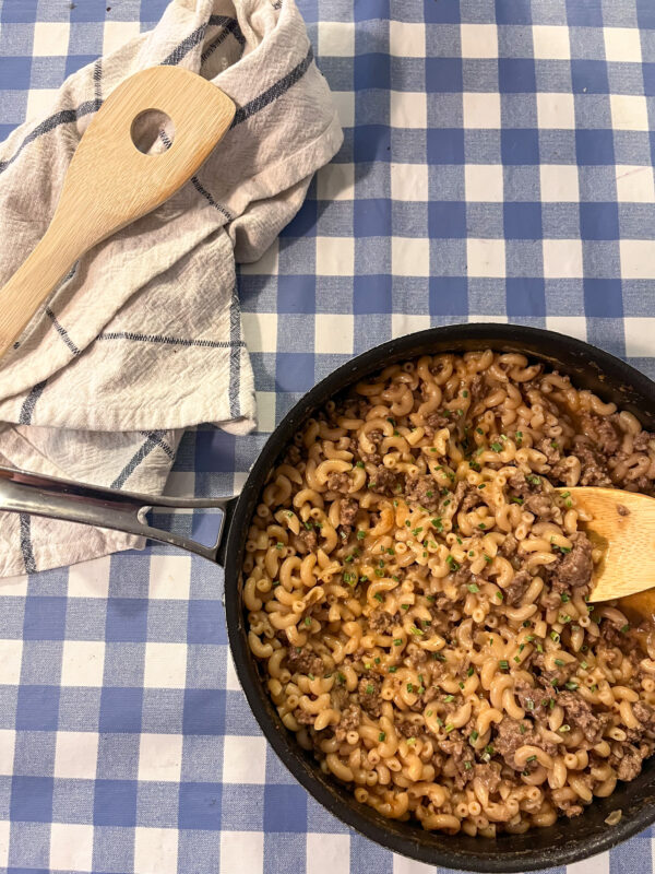 Homemade hamburger helper in a skillet set on a table