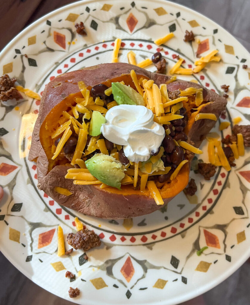Taco stuffed sweet potato served on a plate