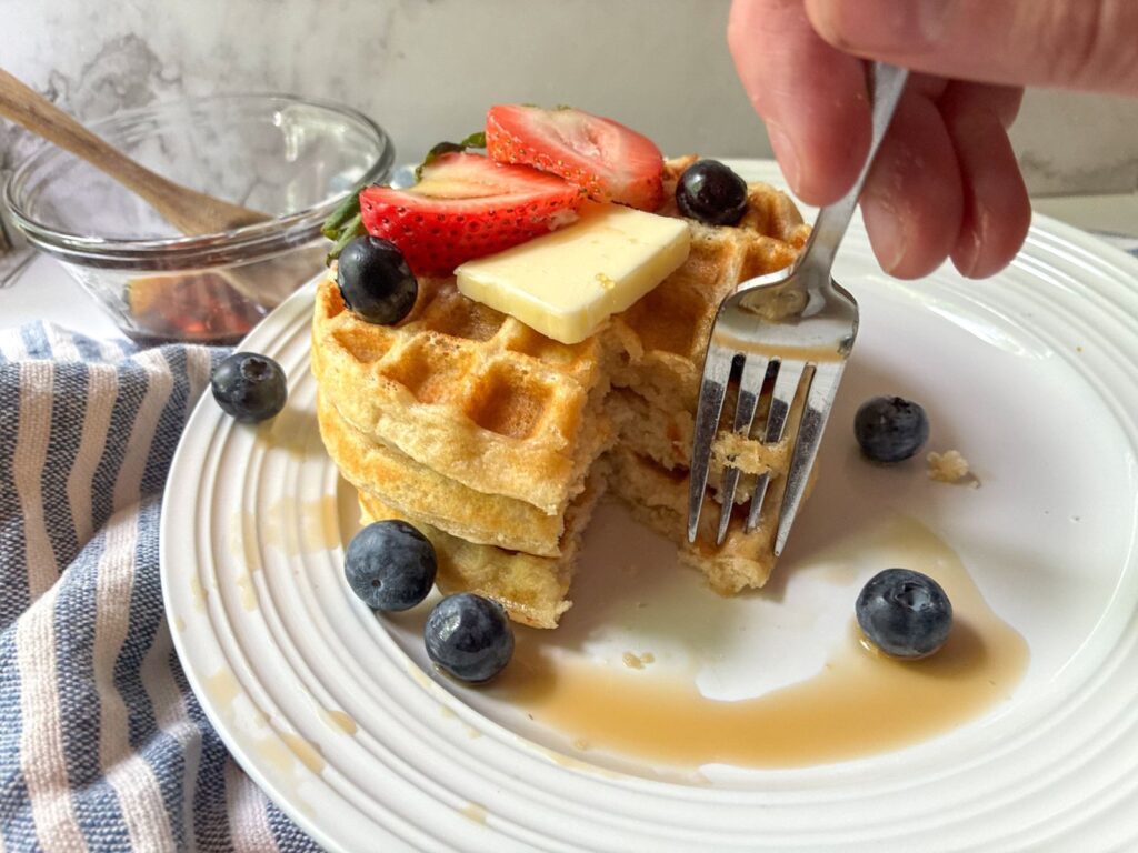 Eggless waffles with a fork going into a stack of them