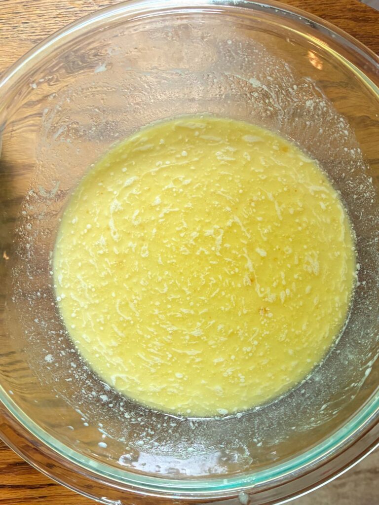 Wet ingredients in a large mixing bowl for eggless waffles