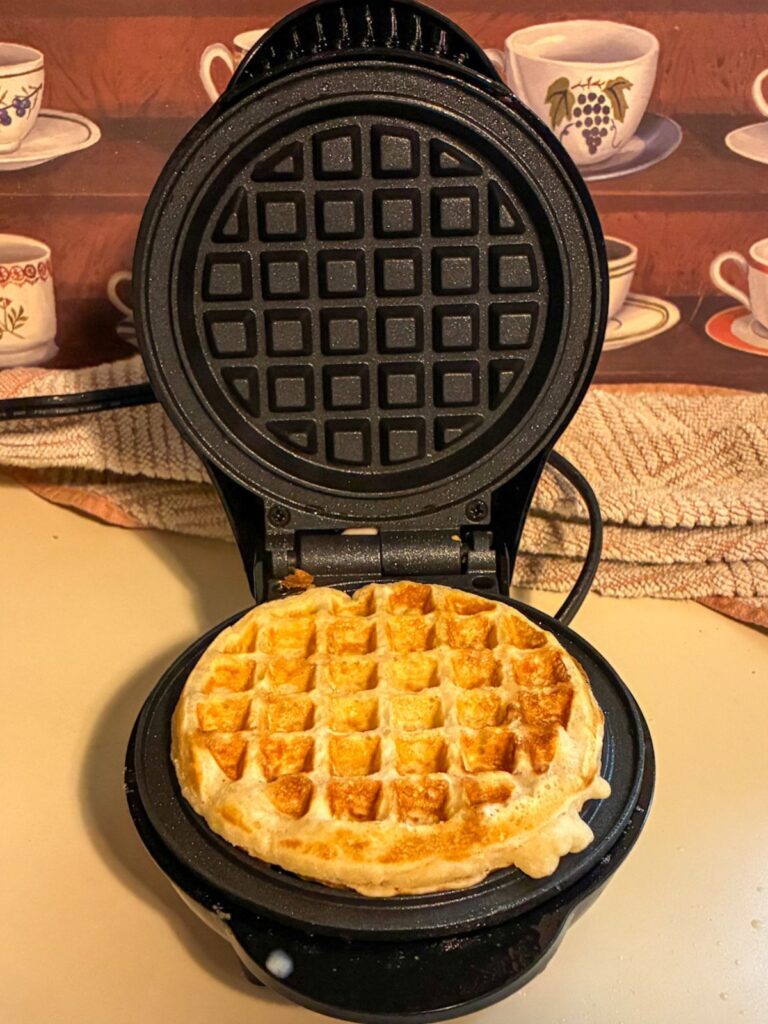Cooked eggless waffle still sitting in the waffle iron