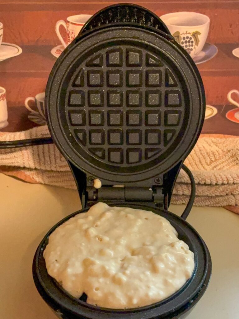 Uncooked batter in the waffle iron for eggless waffles