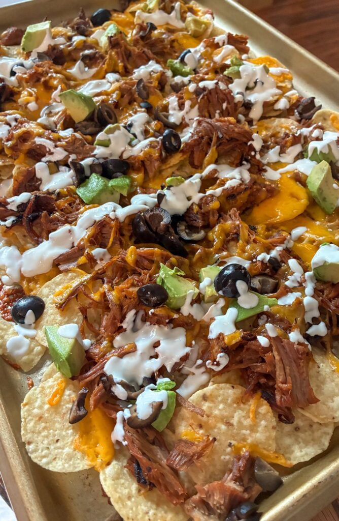 sheet pan pulled pork nachos with all the toppings 