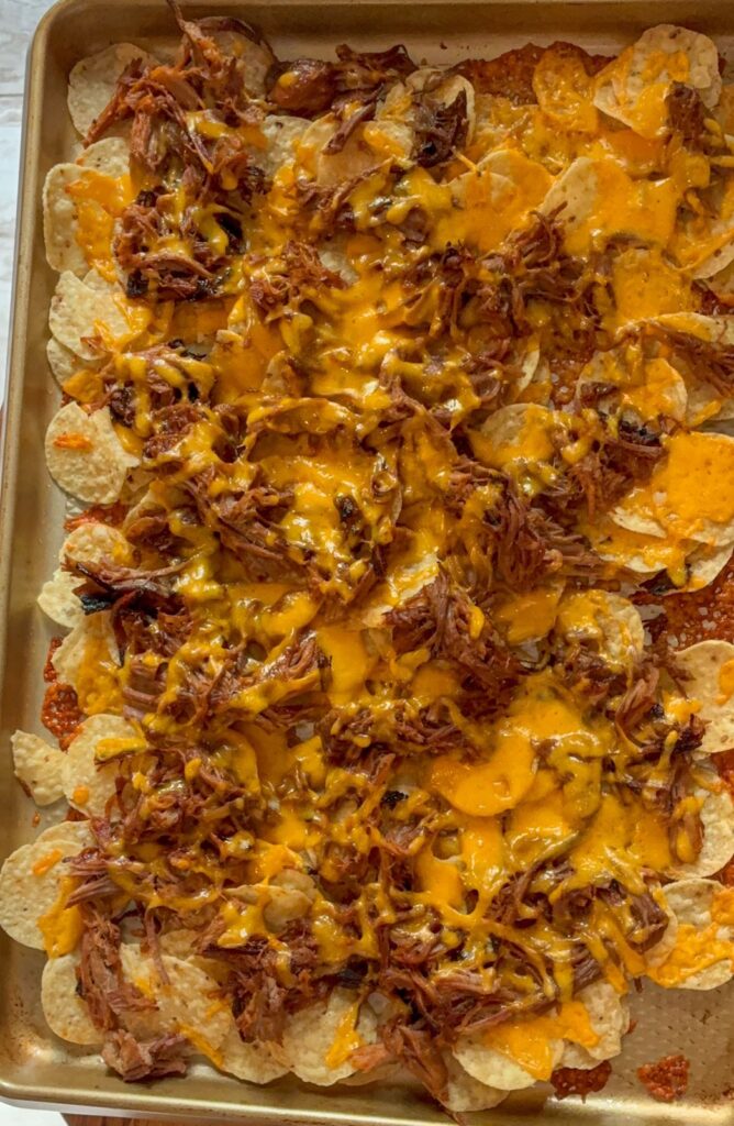 Sheet pan nachos out of the oven prior to additional toppings going on
