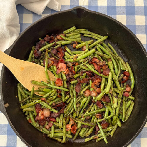 sauteed green beans, bacon, and onion in cast iron skillet