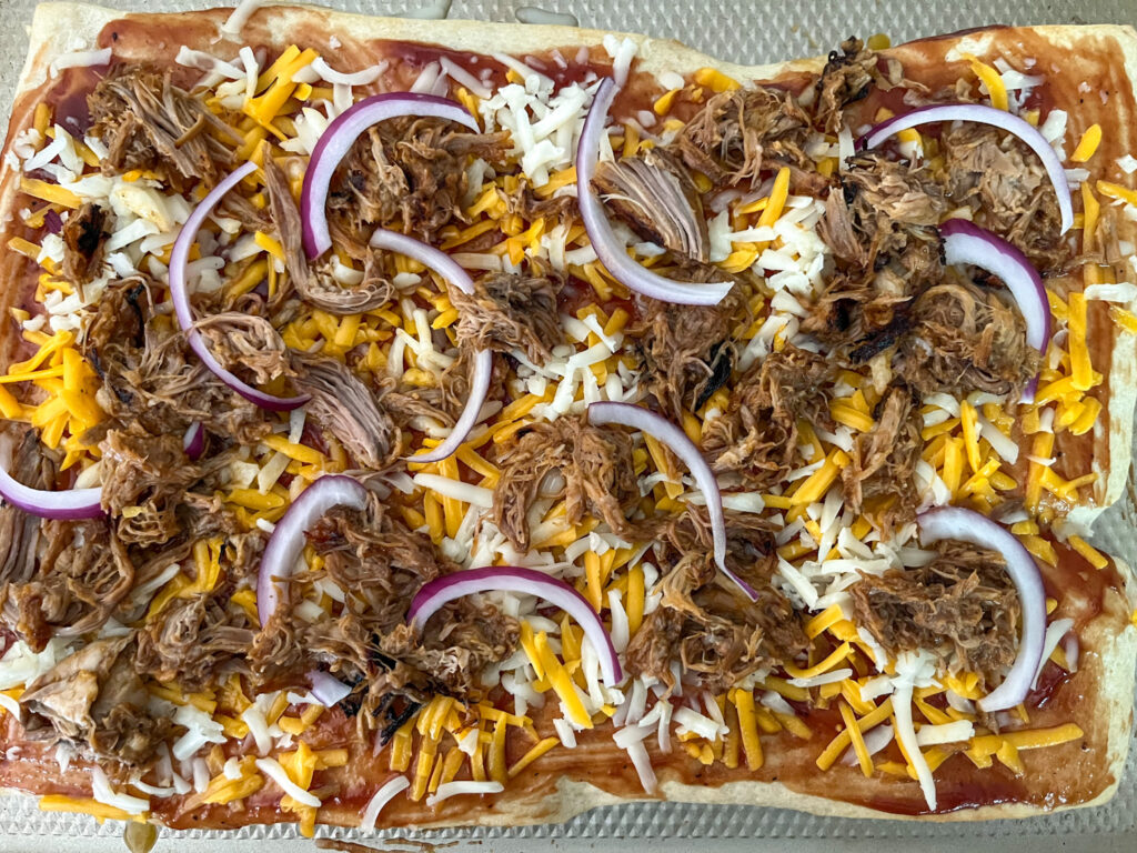 Pizza with toppings on before baking