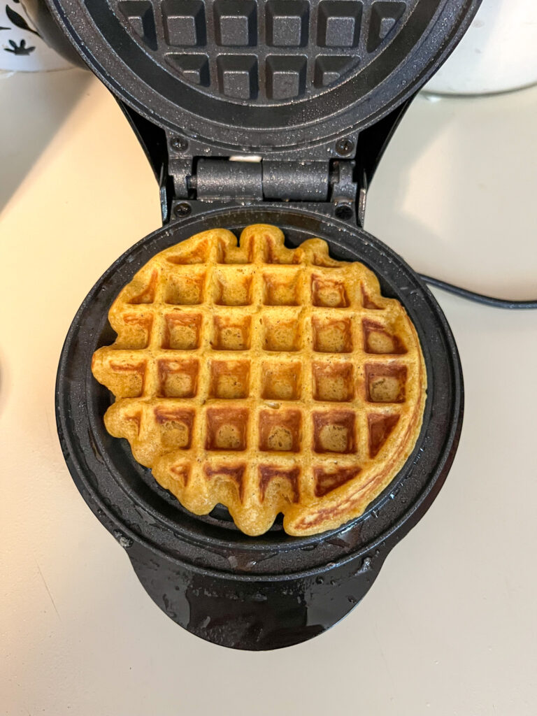 pumpkin waffle cooked and sitting in the waffle iron