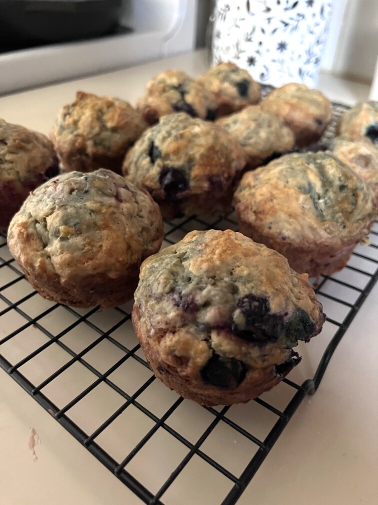 sourdough discard blueberry muffins on a baking sheet