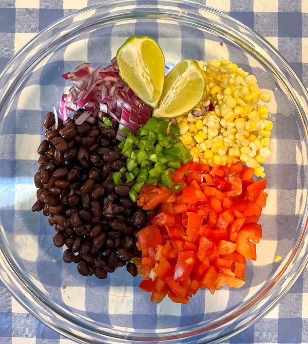corn and black bean salsa ingredients in a large bowl before the ingredients are mixed together