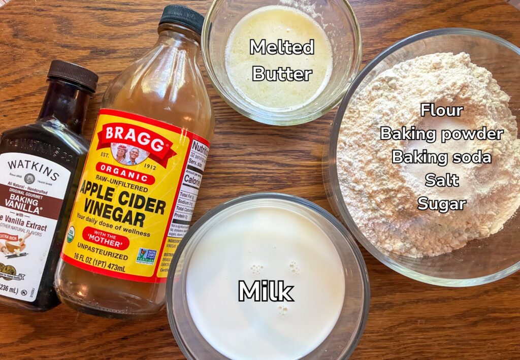 ingredients for eggless pancakes laid out on a table and labeled