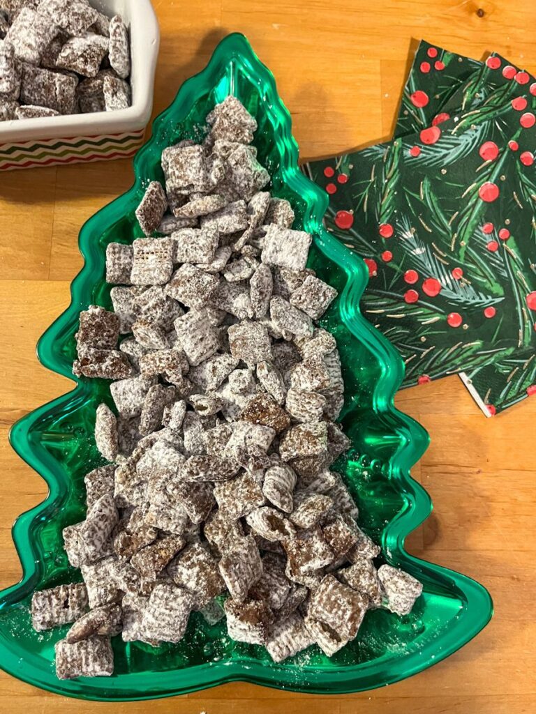 Cookie butter puppy chow served in a Christmas tree shaped dish