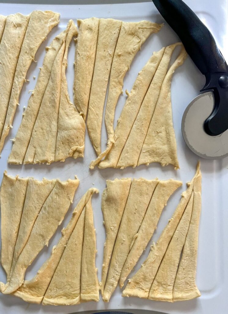 Sliced crescent rolls on a baking sheet