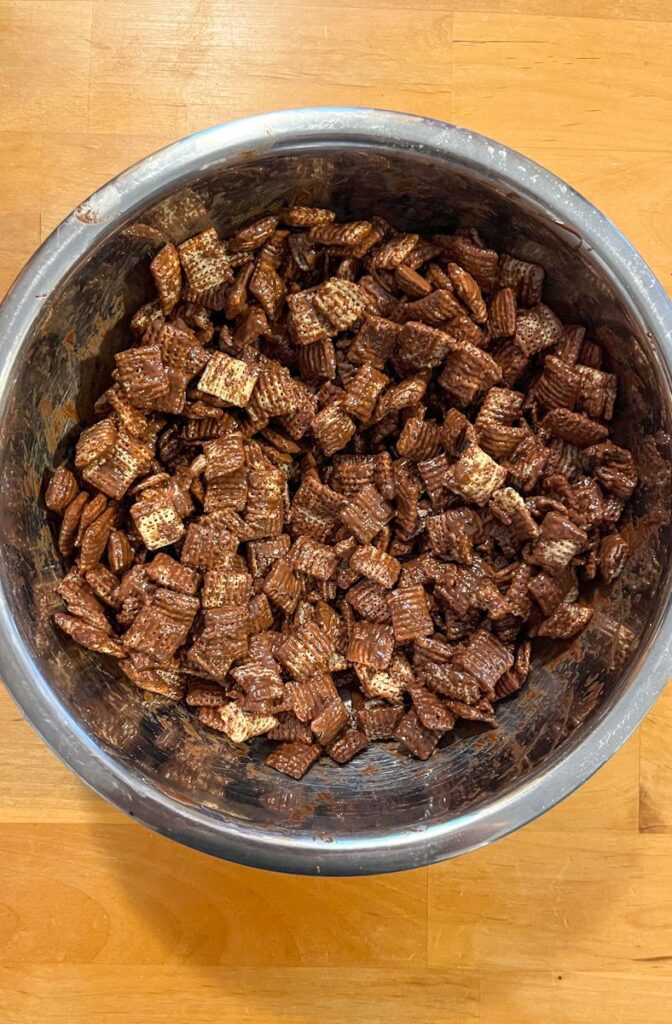 A bowl with rice chex covered in the melted chocolate and cookie butter mixture