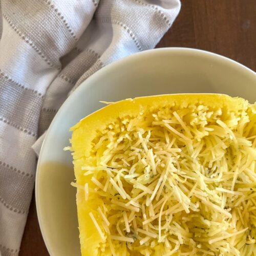 half of a spaghetti squash filled with parmesan cheese