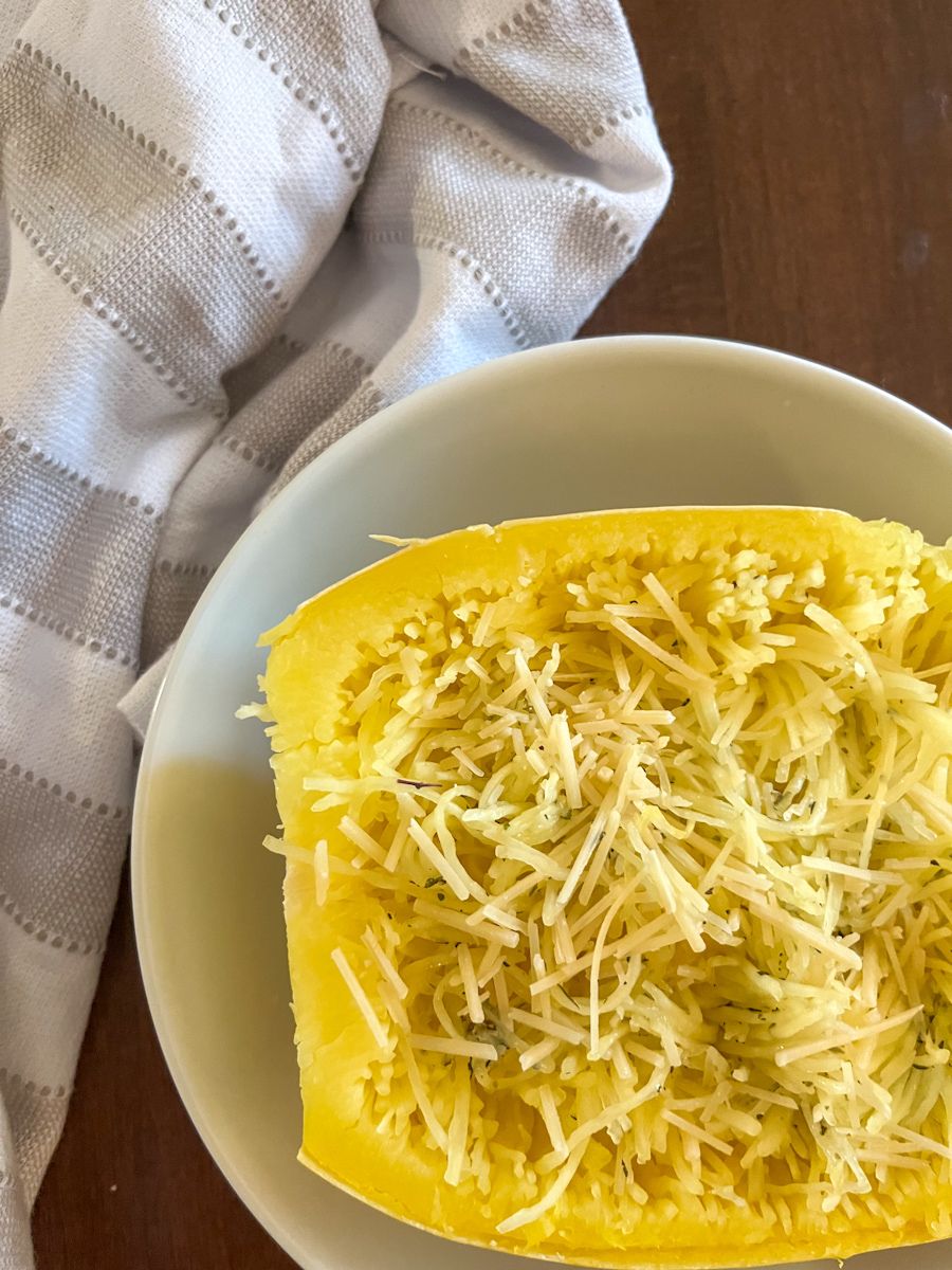 half of a spaghetti squash filled with parmesan cheese