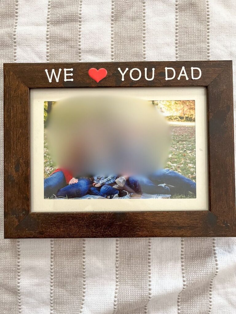 homemade picture frame with stickers saying we love you dad on the top