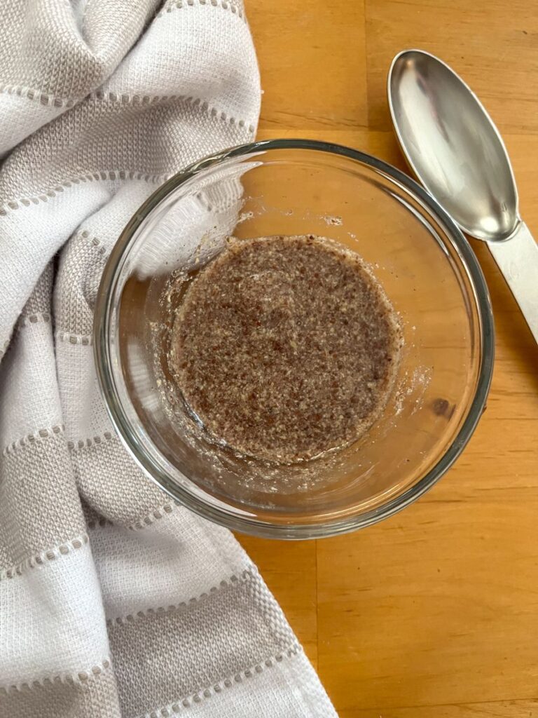 small bowl with a flax egg inside and a tbsp. next to it