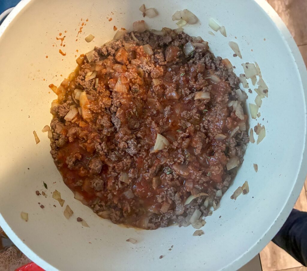 Ground beef, tomato sauce, and spices in a large pot