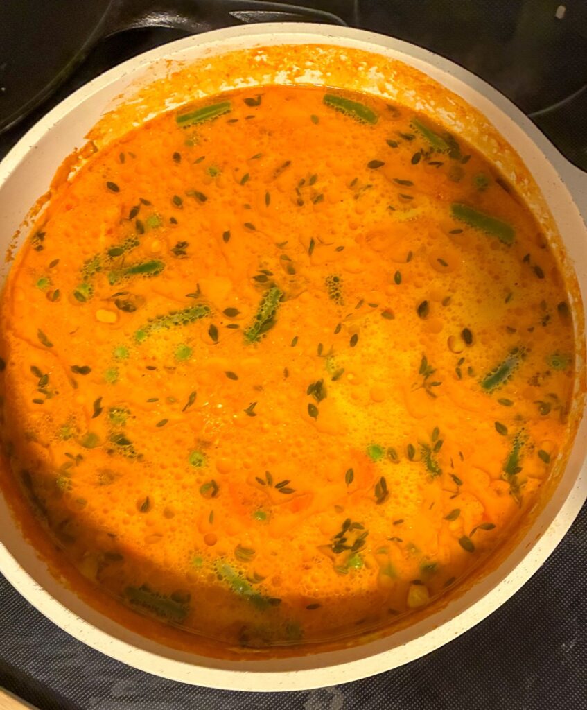Large pot with soup after cream and cheese have been added in