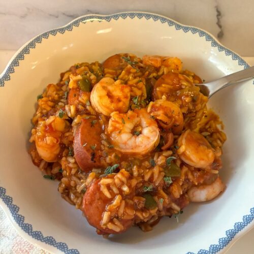 jambalaya in a bowl with a spoon scooping it out