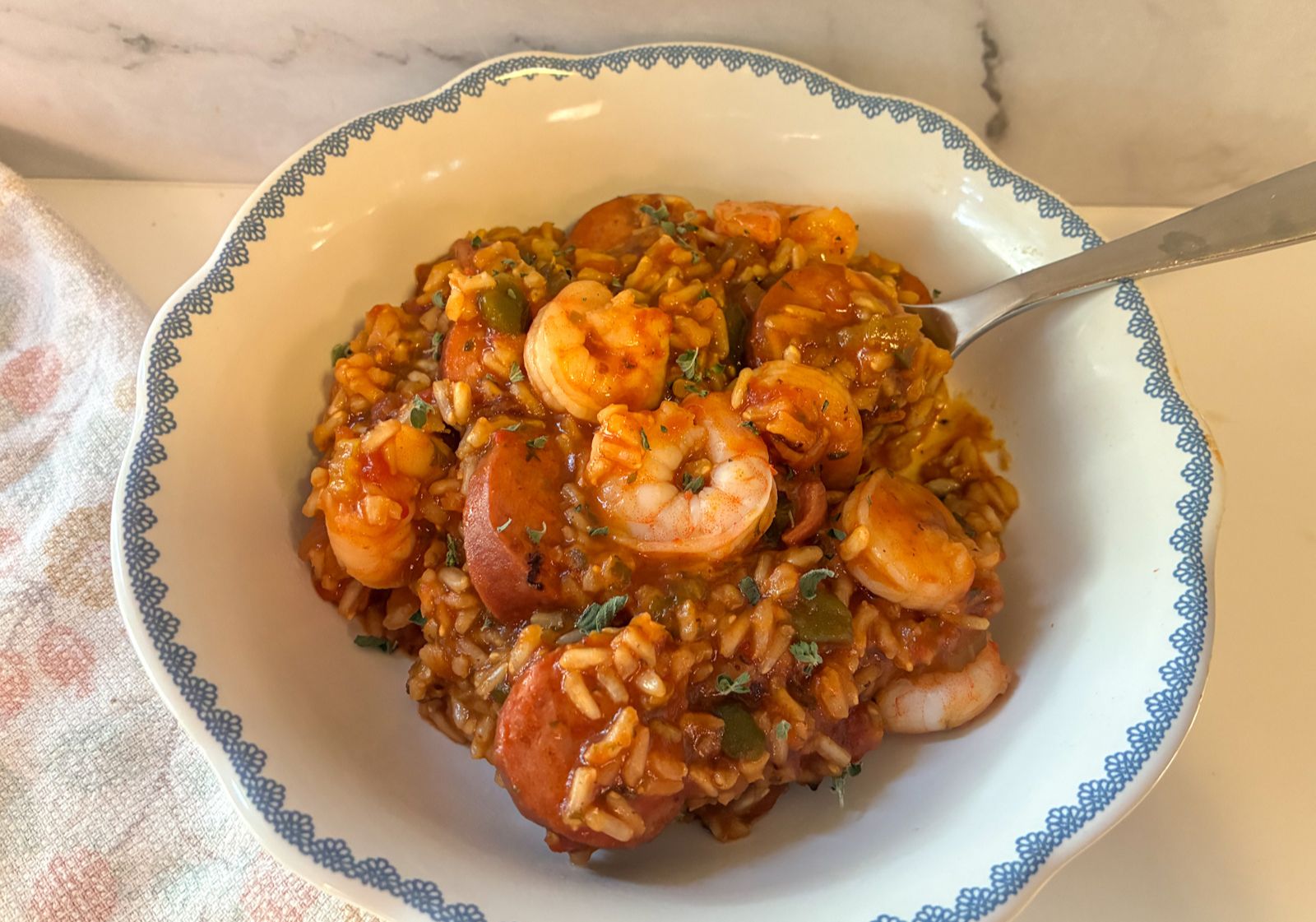 jambalaya in a bowl with a spoon scooping it out