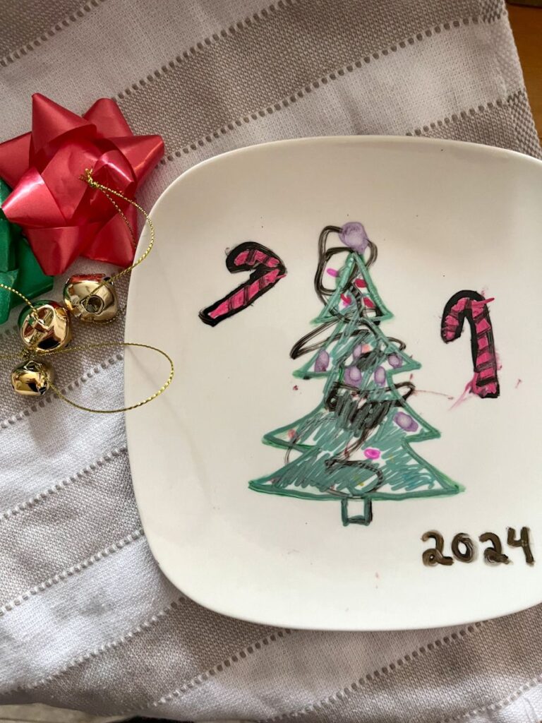 dollar tree painted plate with a Christmas tree and candy canes