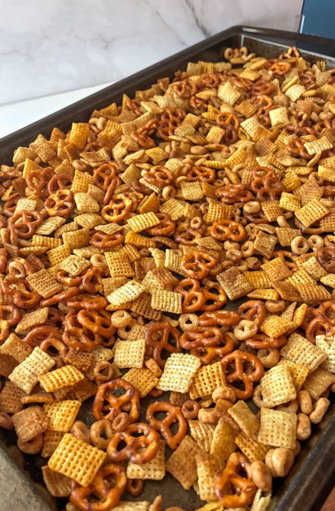 Homemade chex mix fresh out of the oven on a baking sheet