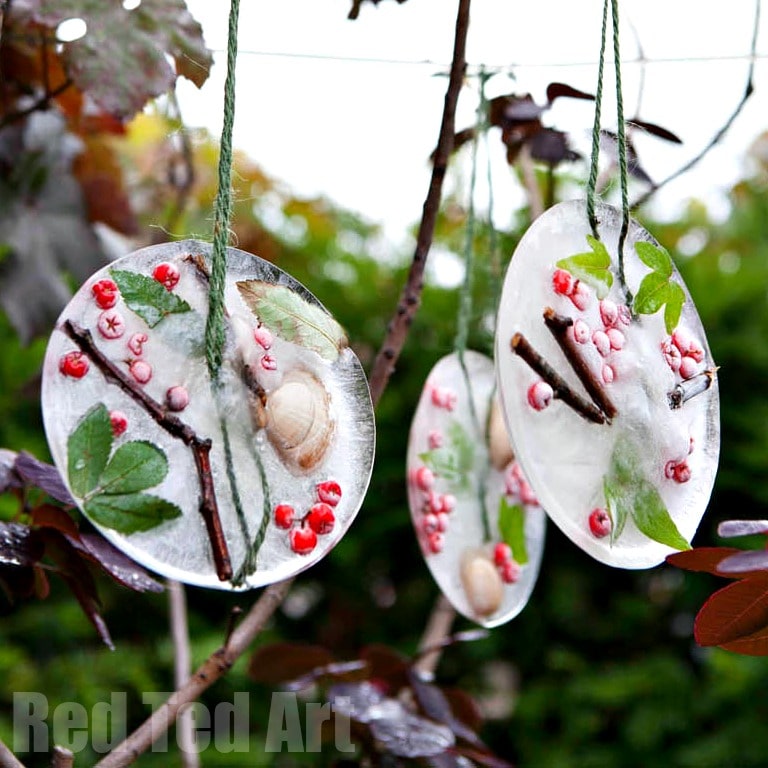 three ice ornaments hanging on a tree