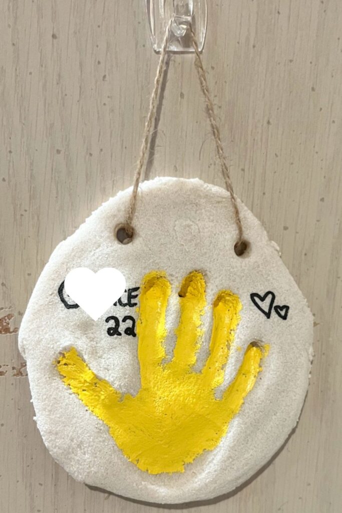 salt dough handprint ornament hanging up on wall