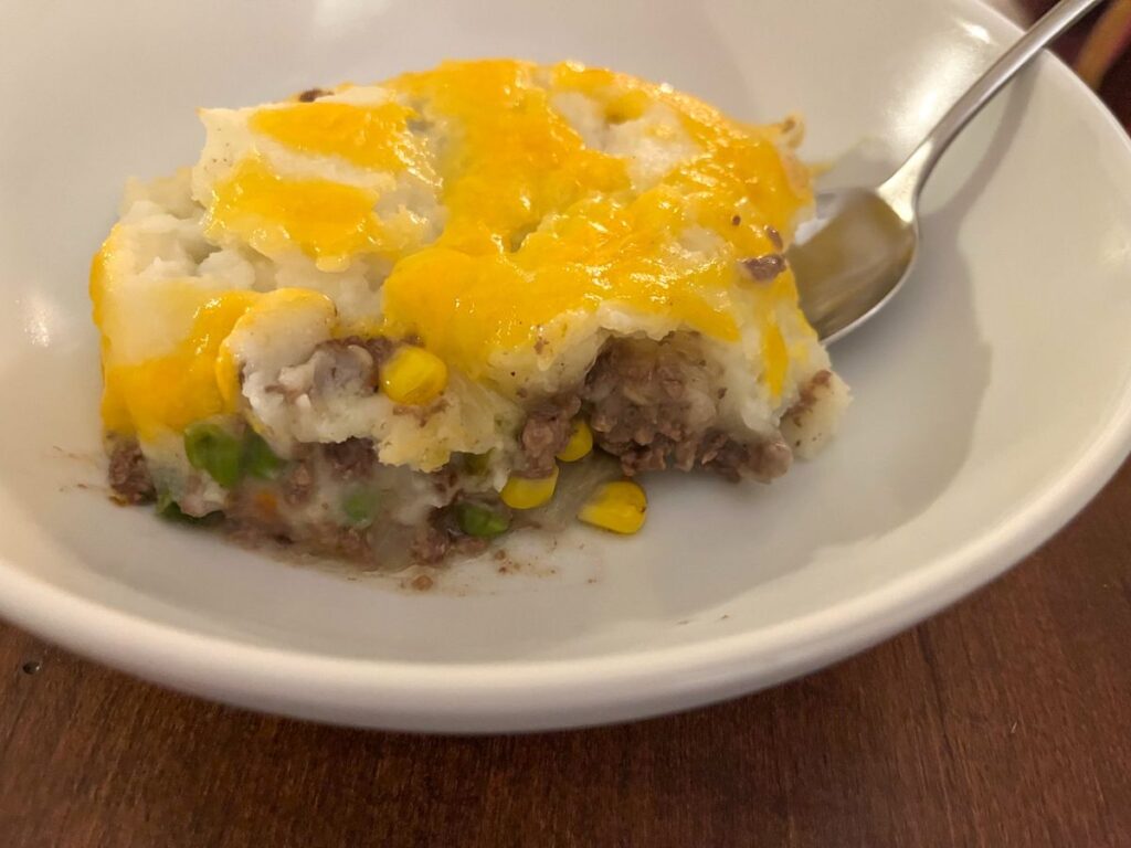 slice of shepherds pie served on a plate with a fork