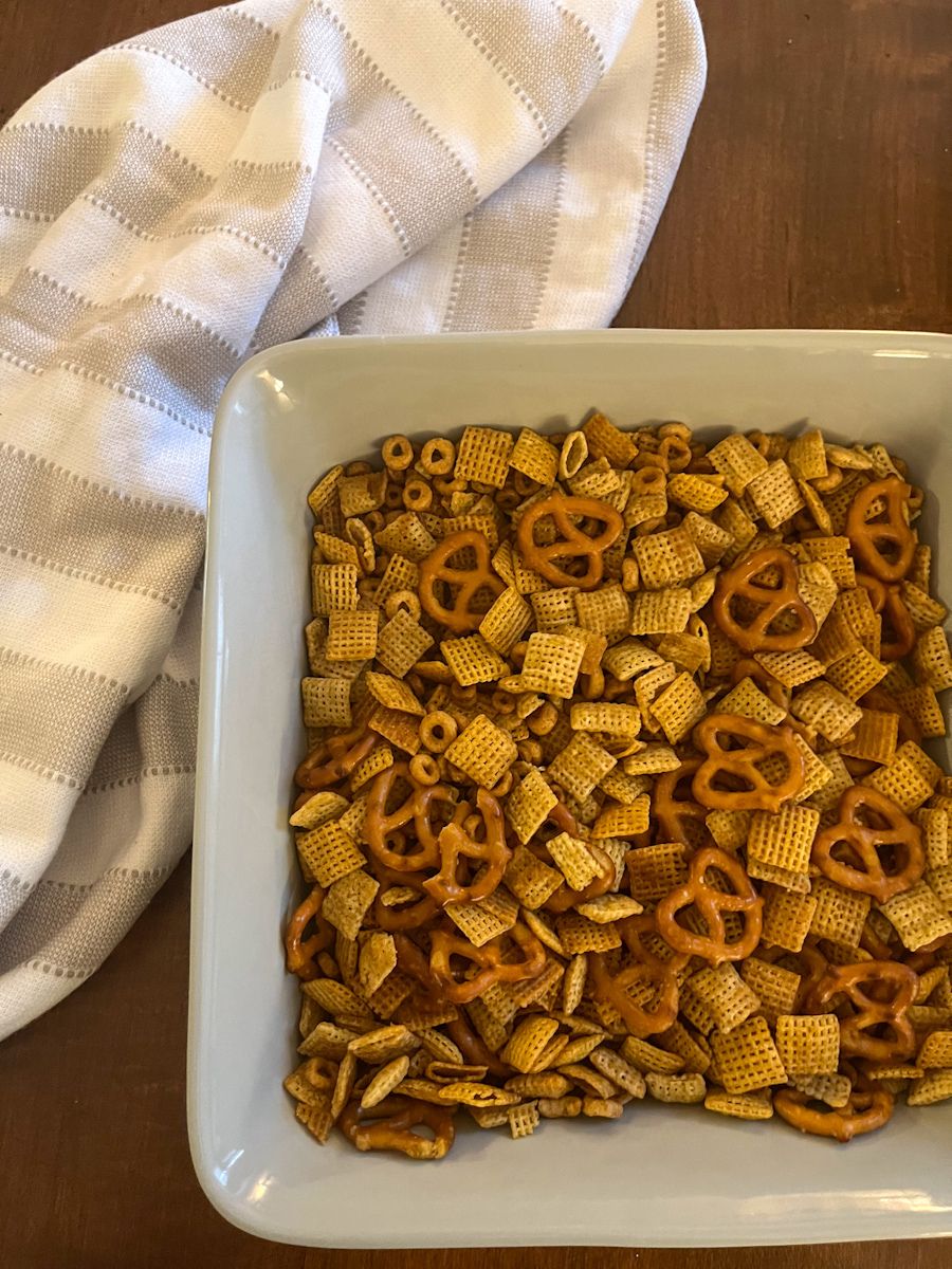 homemade chex mix served in a large square serving dish