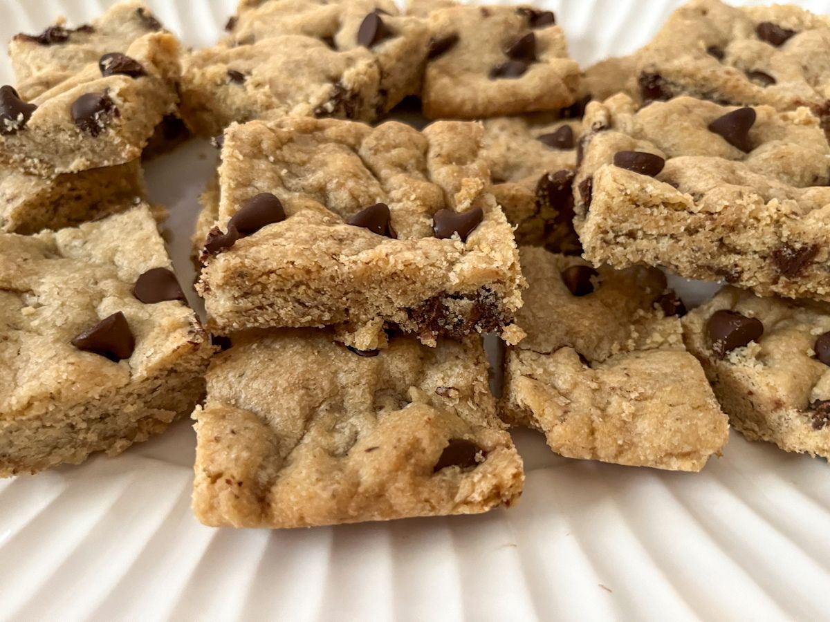 chocolate chip cookie bars without eggs sliced and on a platter