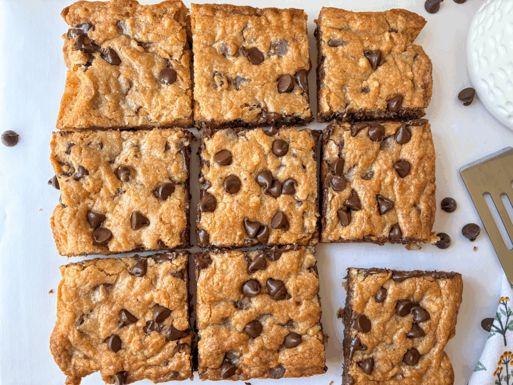 Eggless Chocolate Chip Cookies bars in 9 slices with a cookie spatula next to it