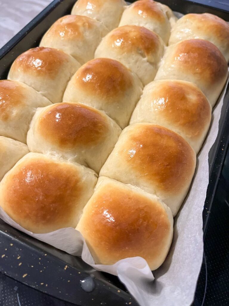 Soft dinner rolls fresh out of the oven and brushed with butter