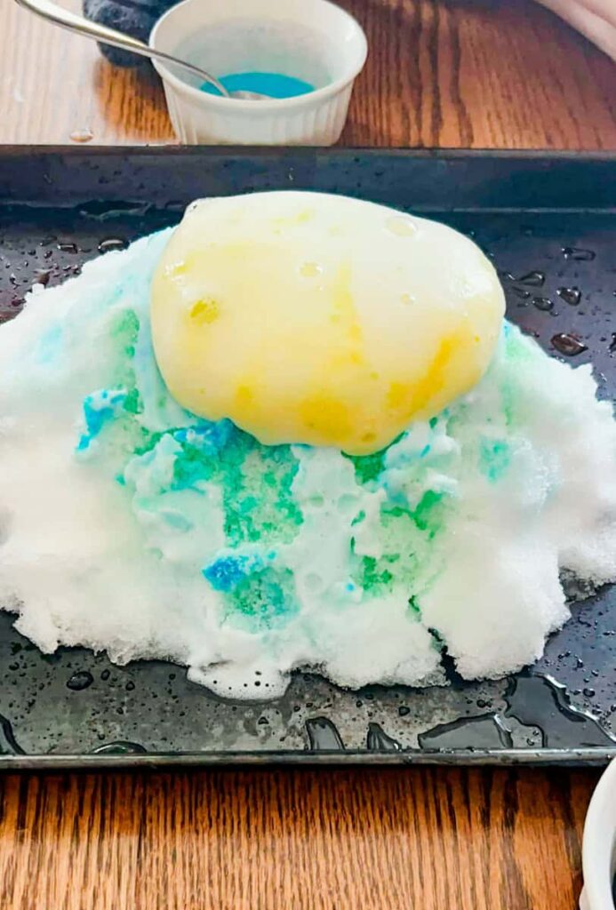 Snow volcano on a baking sheet inside